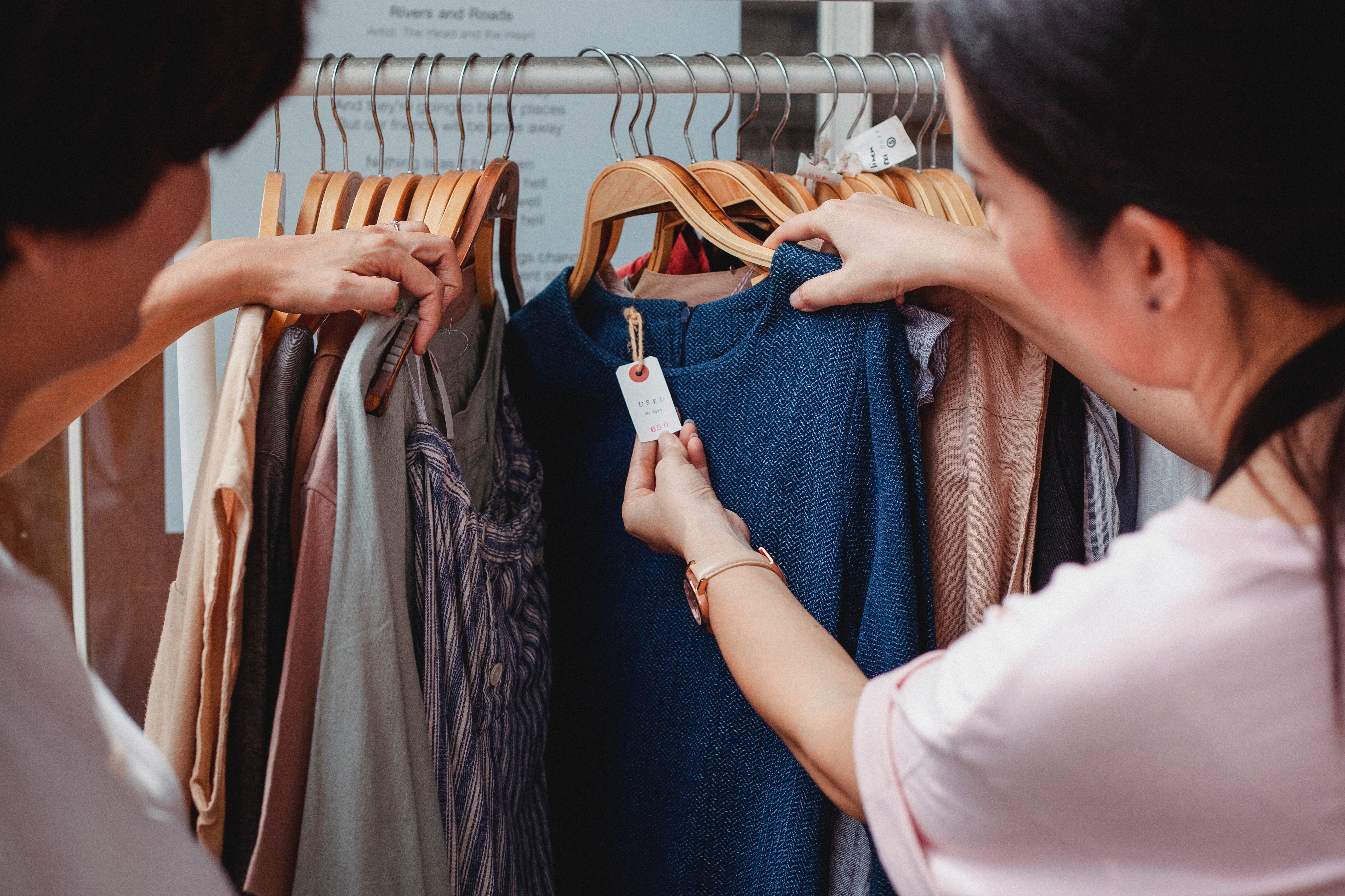 Woman shopping on clothes rack. 